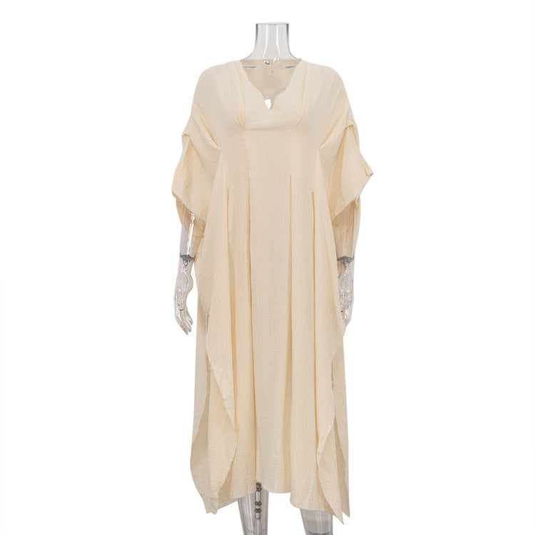 Crinkled fabric dress with a V-neck and long skirt; a loose, breathable dress.