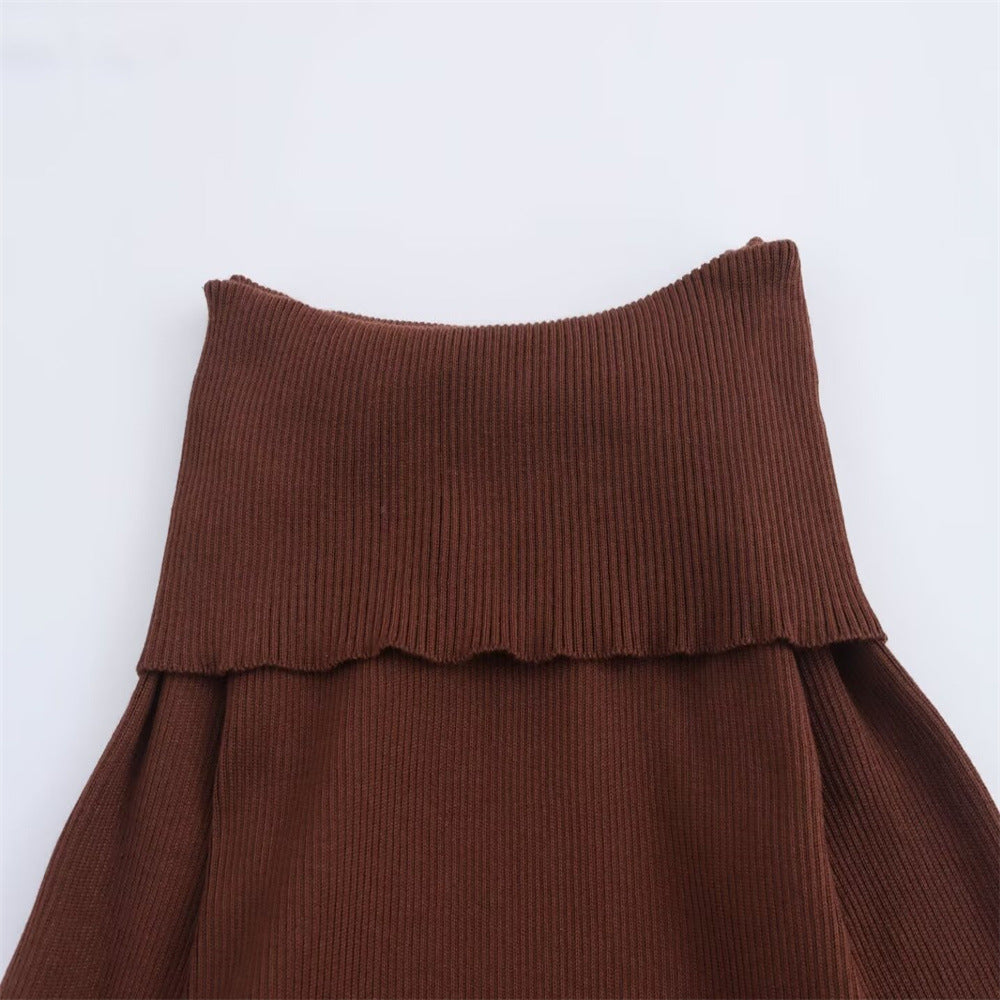 A trendy, minimalist, form-fitting knit dress with long sleeves and an off-the-shoulder neckline.