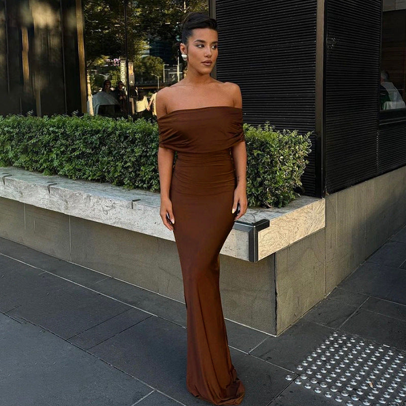 Form-fitting, long off-the-shoulder dress with an open back.