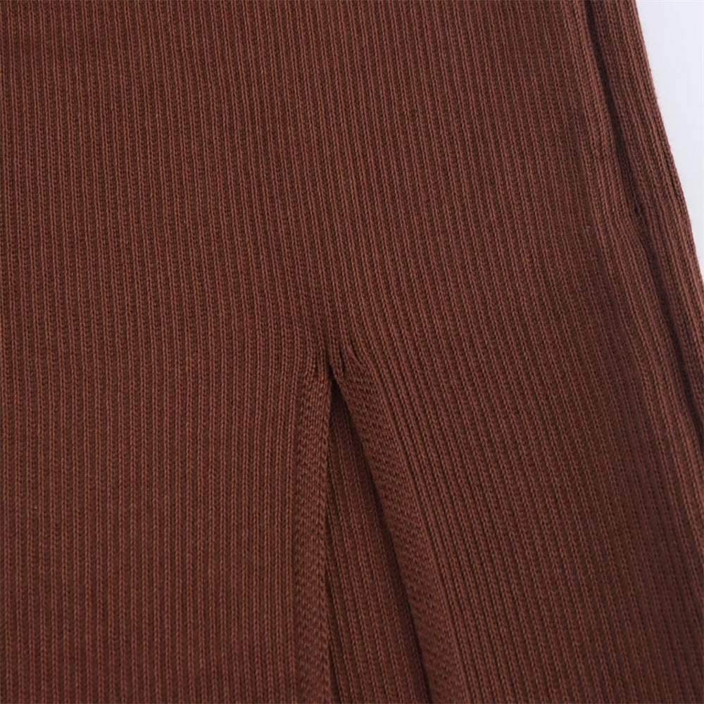 A trendy, minimalist, form-fitting knit dress with long sleeves and an off-the-shoulder neckline.