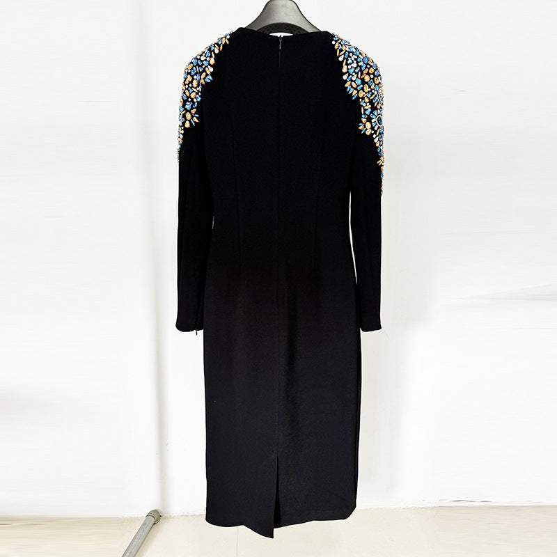 A mid-length, long-sleeved dress richly embellished with beads and rhinestones.