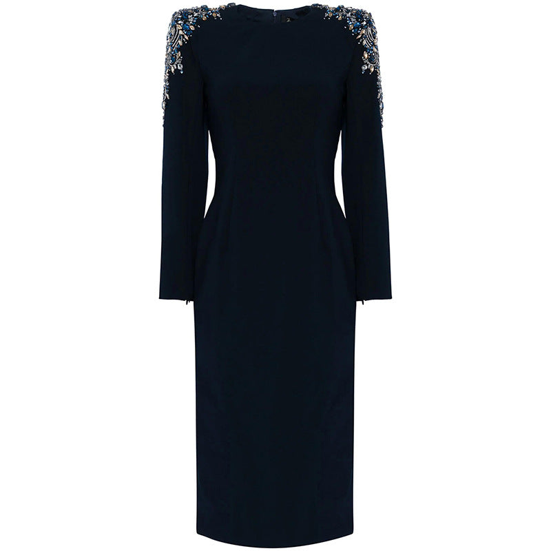 A mid-length, long-sleeved dress richly embellished with beads and rhinestones.