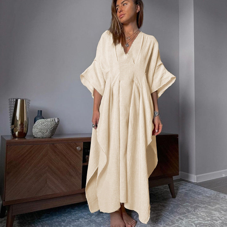 Crinkled fabric dress with a V-neck and long skirt; a loose, breathable dress.
