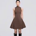 A short, sleeveless dress featuring symmetrical pleats, a metal buckle, and a waist accent.